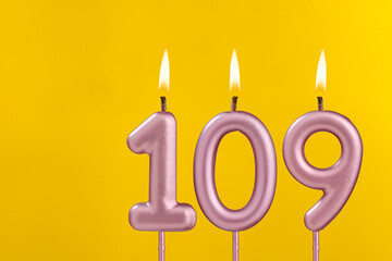 Candle 109 with flame - Birthday card on yellow luxury background