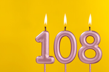 Birthday candle number 108 - Birthday celebration on yellow background