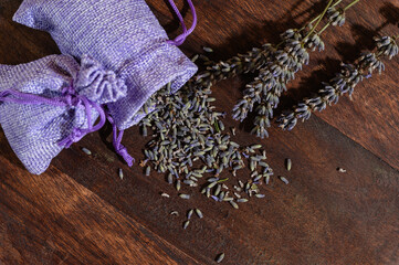 Aroma sachet with lavender flowers on a wooden background.