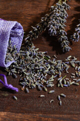 Aroma sachet with lavender flowers on a wooden background.