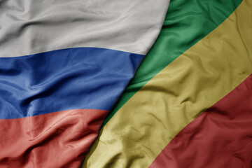 big waving realistic national colorful flag of russia and national flag of republic of the congo .