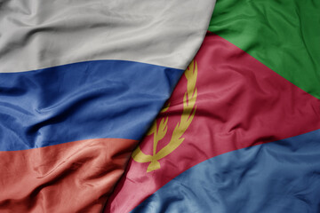 big waving realistic national colorful flag of russia and national flag of eritrea .