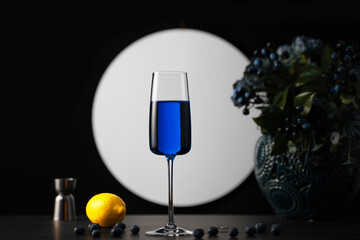 glass of blue lagoon cocktail drink, lemon and blueberry, dark beverage wallpaper