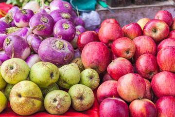 Purple turnips, pears, and apples at a market in a village of Jammu and Kashmir.