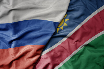 big waving realistic national colorful flag of russia and national flag of namibia .