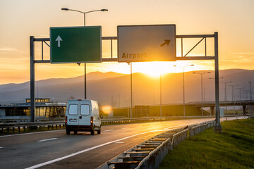 White van on the road going to the west with sunset in the background. Fast delivery, cargo logistic and freight shipping concept