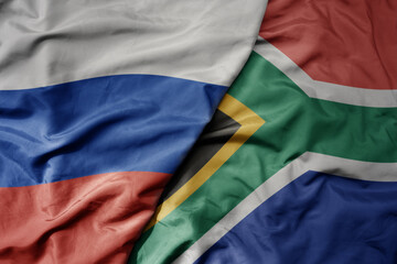 big waving realistic national colorful flag of russia and national flag of south africa .