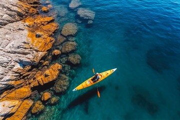Fototapeta na wymiar Aerial view of person in kayak in blue sea. Woman kayaking in blue water.