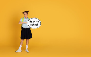 Positive caucasian teenager girl show abstract cloud with inscription back to school