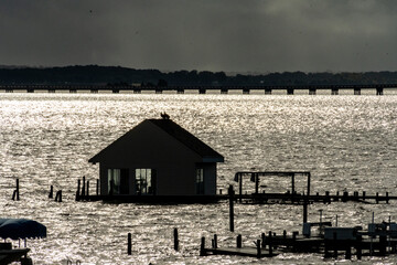 Dramatic Clouds over the rappahannock river behind the boat house with the Downing Bridge in the...
