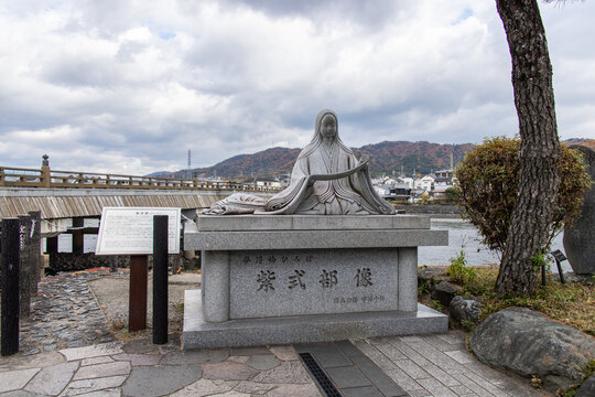 Uji, JAPAN - Dec 4 2021 : Statue of a Japanese novelist, poet and lady-in-waiting at the court in the Heian Era Murasaki Shikibu at Uji River. She is best known as the author of The Tale of Genji