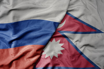 big waving realistic national colorful flag of russia and national flag of nepal .