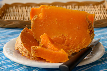 Pieces of native French aged cheese Mimolette, produced in Lille with greyish curst made by special...
