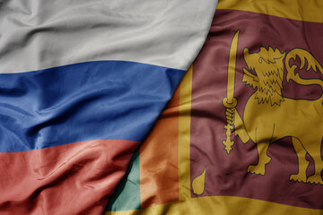 big waving realistic national colorful flag of russia and national flag of sri lanka .