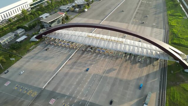 Aerial view pull away from Bandar Cassia Toll Plaza in evening