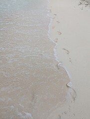 Foot prints and waves at Caribbean Sea