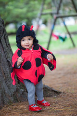 Little baby girl wearing a ladybug costume. Halloween concept. © anamejia18