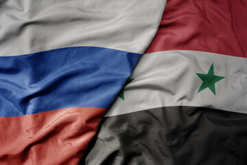 big waving realistic national colorful flag of russia and national flag of syria .