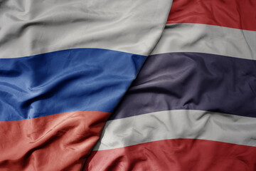 Fototapeta premium big waving realistic national colorful flag of russia and national flag of thailand .