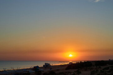 Fototapeta na wymiar Orange-gold sunset, sky, sunlight, summer mood landscape with sea sunset on beach.