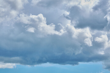 Fototapeta na wymiar Cumulus clouds against a light blue sky with a clear fiber structure.