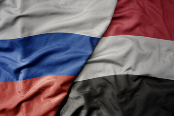 big waving realistic national colorful flag of russia and national flag of yemen .