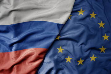 big waving realistic national colorful flag of russia and national flag of european union.