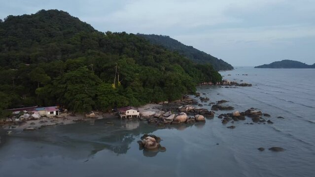Scenic landscape with a beach and lush forest at Permatang Damar Laut