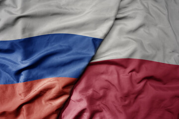 big waving realistic national colorful flag of russia and national flag of poland .