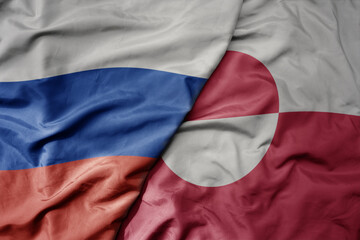 Fototapeta premium big waving realistic national colorful flag of russia and national flag of greenland .