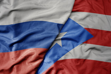 big waving realistic national colorful flag of russia and national flag of puerto rico .