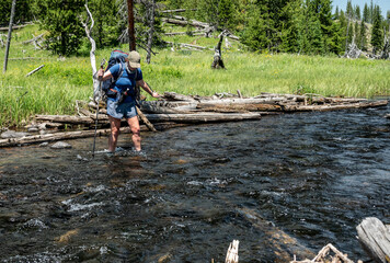 Woman Crosses Creek Flowing out of Grizzly Lake