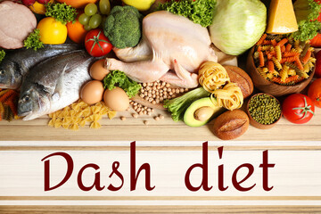Dietary approaches to stop hypertension. Many different healthy food and words Dash diet on wooden...