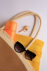 Flat lay composition with sunscreen and beach accessories on white background