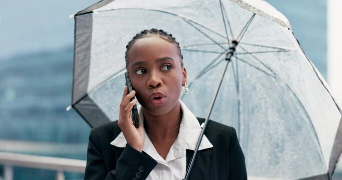 Phone call, argument and upset woman with umbrella in the city on the rooftop of her office building. Conflict, raining and angry African female person on mobile conversation on balcony in urban town