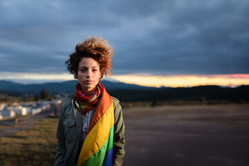 Portrait of a young woman with the rainbow flag. Generative AI.