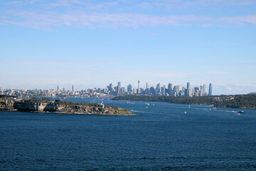 Naklejka premium The City of Sydney Australia Viewed From North Head. Looking over Sydney Harbour filled with sailing boats
