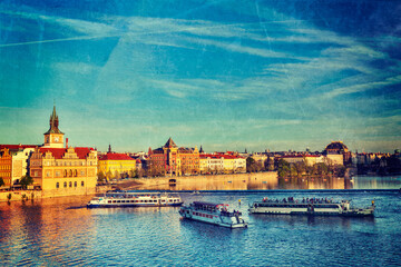 Vintage retro hipster style travel image of Vltava river with tourist boats and Prague Stare Mesto...
