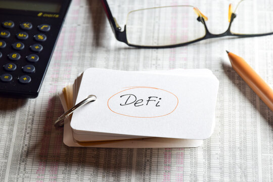 Abbreviation of Decentralized Finance (DeFi) handwriting on ring note. Digital financial technology concept. 