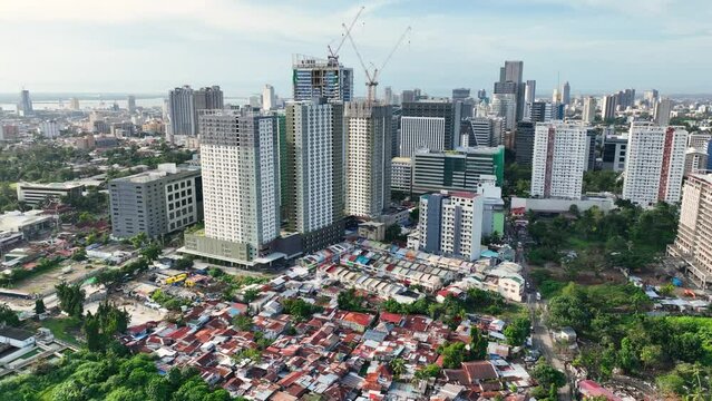 Aerial shot of the poor neighborhoods mixed in with new modern high-rises in Cebu City Philippines.