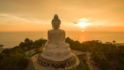 .aerial view colorful yellow cloud in golden sky in sunset at Phuket big Buddha..creative travel concept. stunning yellow sky background..Phuket big Buddha is the popular landmark in Phuket.