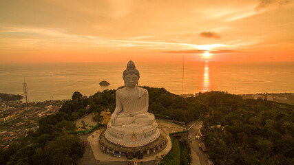 .aerial view Phuket big Buddha in beautiful sunset..amazing sun shines through the yellow clouds...