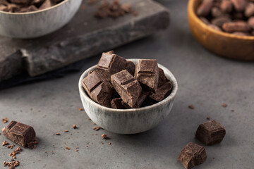 Cubes of dark artisan chocolate in a bowl. Bitter chocolate