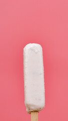 Vertical front view Popsicle sticks isolated on pink background.