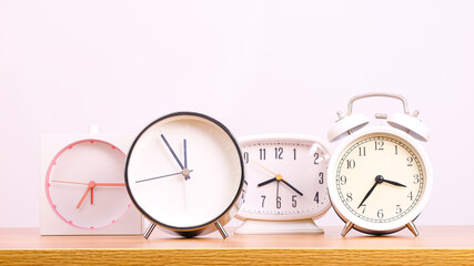 Close-up Front view, 5 alarm clocks on a white background.