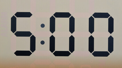 Close-up Front view Digital LCD clock shows 5:00 Time concept.