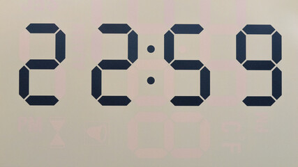 Close-up Front view Digital LCD clock shows 22:59, Time concept.