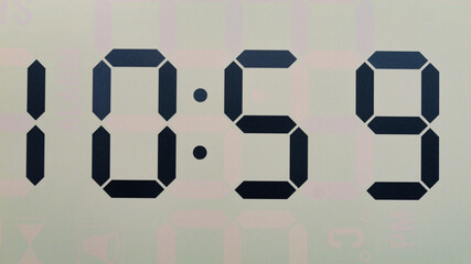 Close-up Front view Digital LCD clock shows 10:59, Time concept.