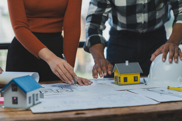 Engineer team working in office with blueprints Planning meeting for architectural work construction project business house structure design real estate concept.