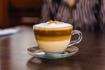 Cup of coffee served on a table.